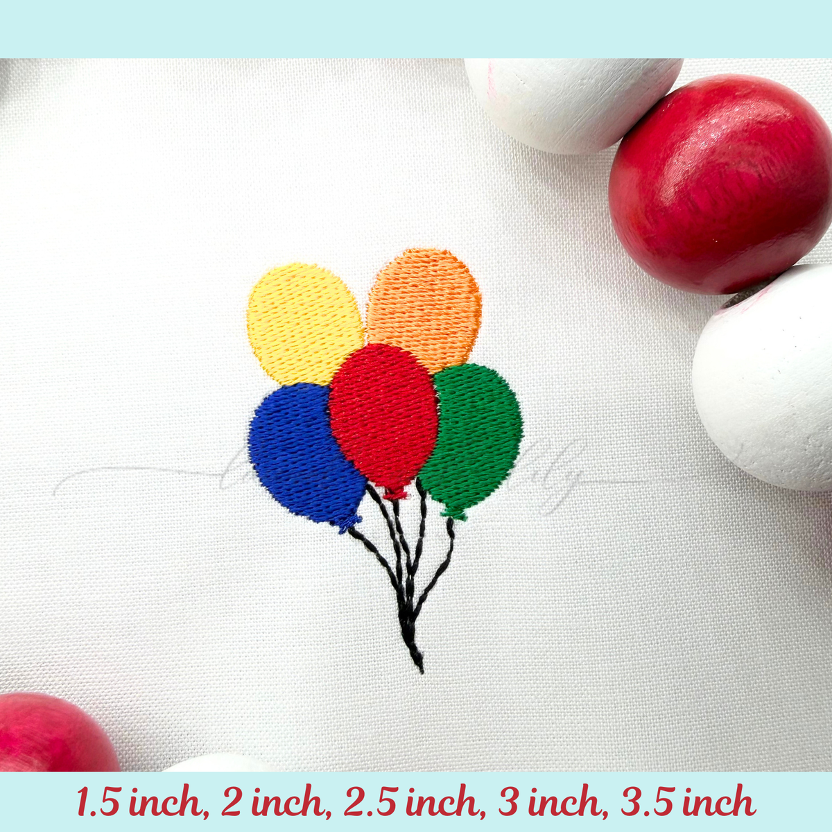 Embroidered colorful balloons on fabric with red and white stones.