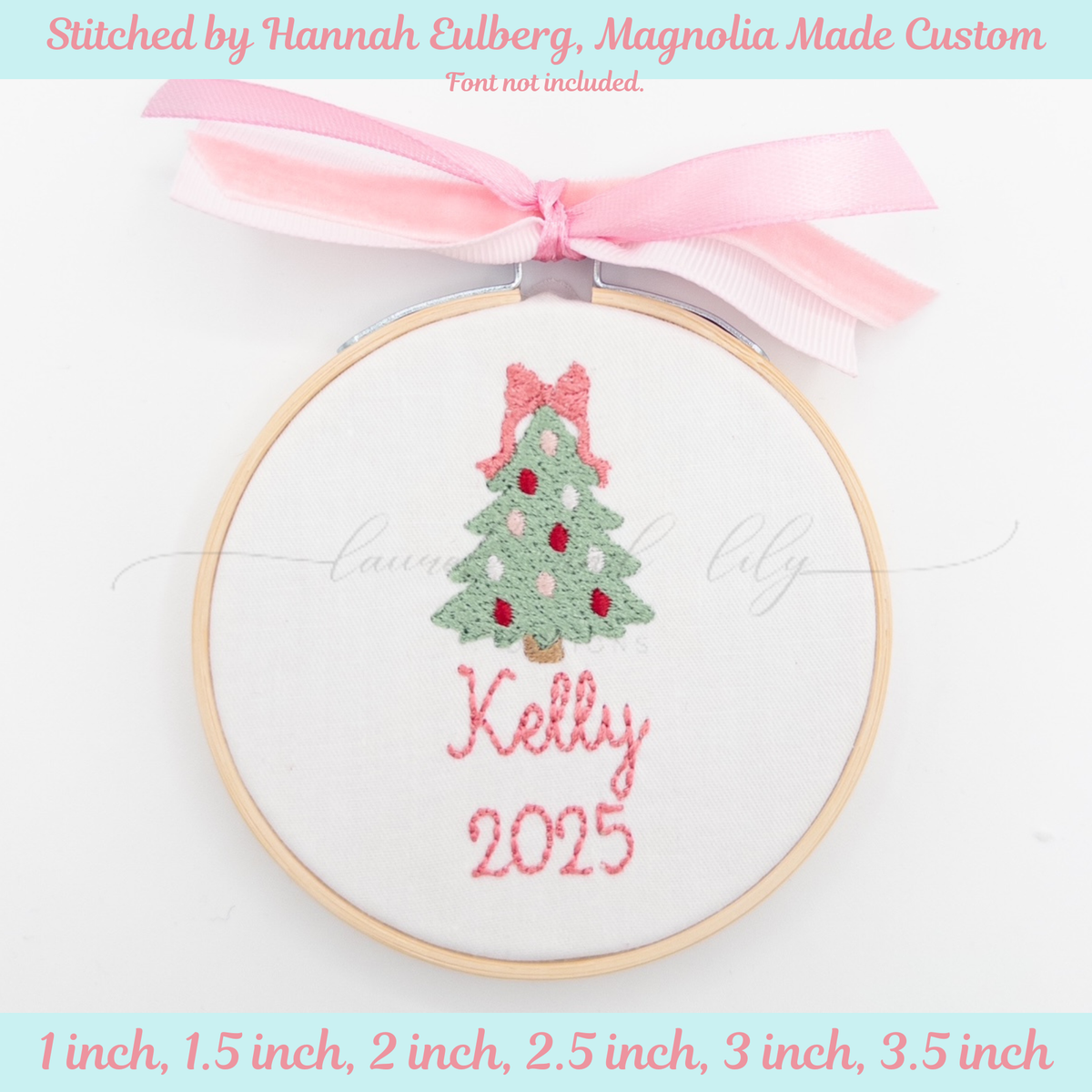 Embroidery hoop with a Christmas tree design and 'Kelly 2025' text, tied with a pink ribbon on a light blue background.