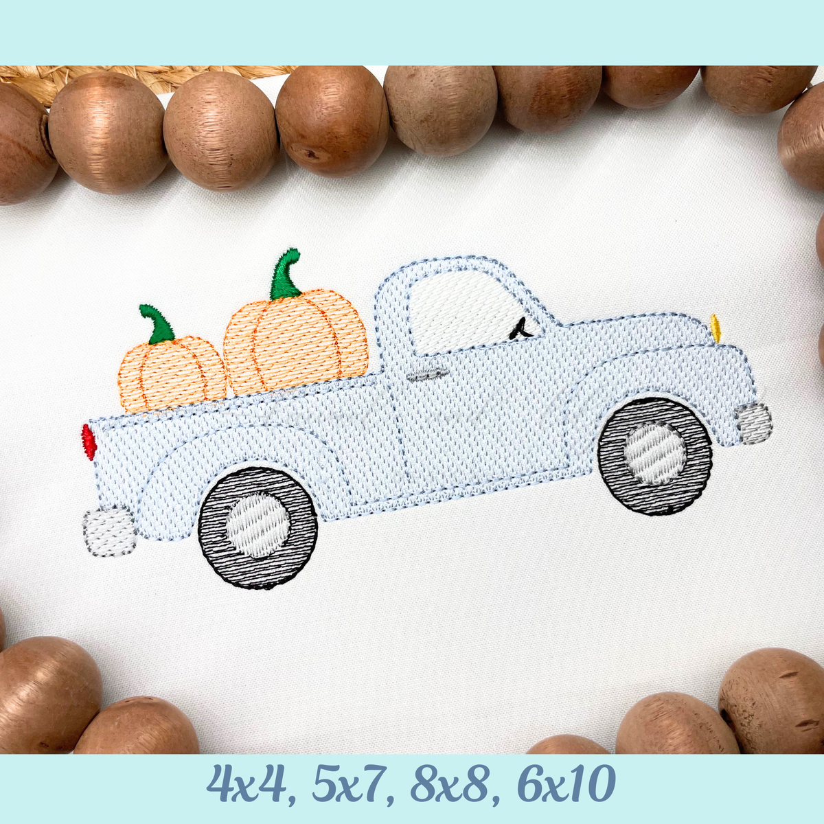 Embroidery design of a blue truck with pumpkins on a white background, surrounded by wooden beads.