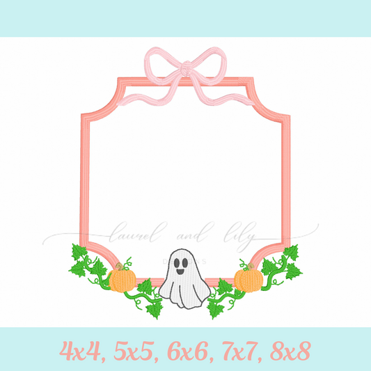 Decorative monogram frame with a ghost, pumpkins, and a bow